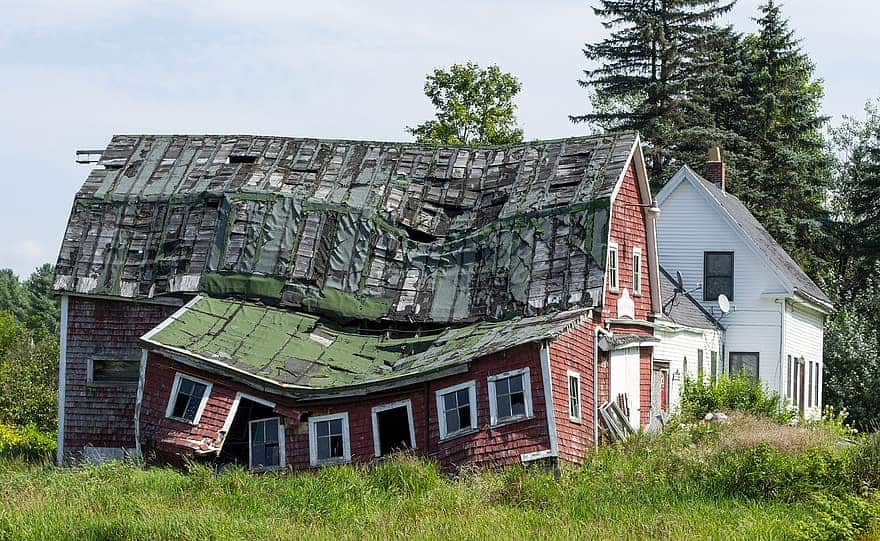 A barn with a badly damaged roof