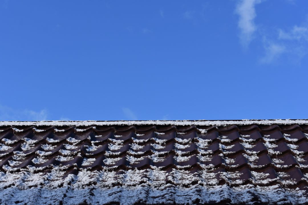 a frosty roof thaws in the sun